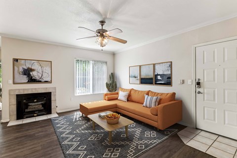 a living room with a couch and a ceiling fan